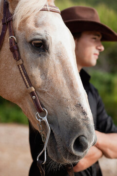 man standing next to horse