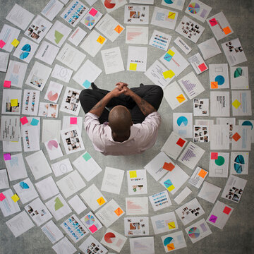Businessman surrounded by papers