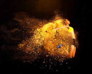 Young woman mid air emerging from yellow powder explosion