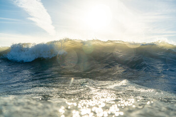 Breaking Waves and spray, white water and light reflected on the surface of the water
