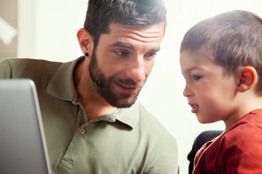 Father and son using laptop