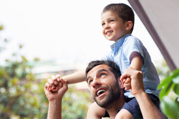 Father carrying son on shoulders