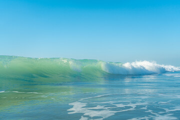 Breaking Waves and spray, white water and light reflected on the surface of the water