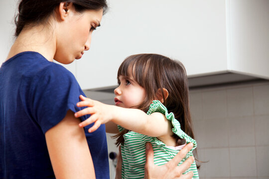 Daughter trying to hug mother