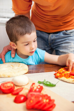 Boy making homemade pizza
