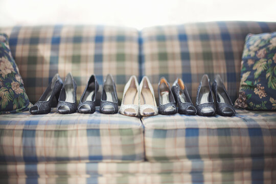 Row of shoes on sofa