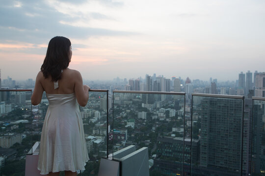 Woman on balcony, Bangkok, Thailand