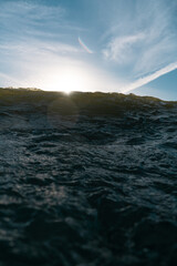 Breaking Waves and spray, white water and light reflected on the surface of the water