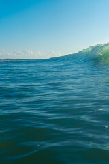 Breaking Waves and spray, white water and light reflected on the surface of the water