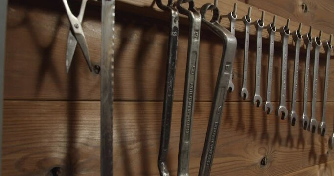 Tools hanging on wooden wall in professional workshop garage