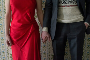 Couple holding hands, mid section