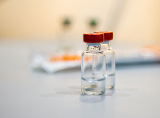 closeup of two vaccine bottles, selective focus