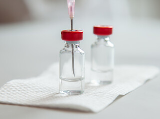 vaccine bottles and syringe for injection