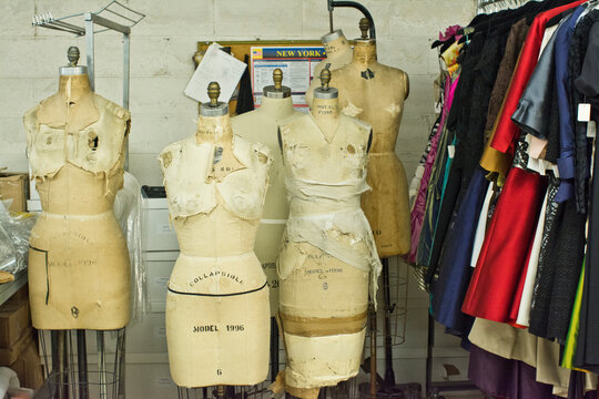 Tailors dummies and clothes rail in fashion design studio