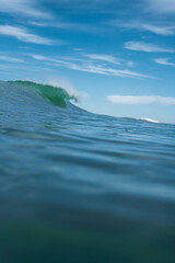 Breaking Waves and spray, white water and light reflected on the surface of the water