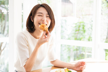 サラダとパンを食べる女性