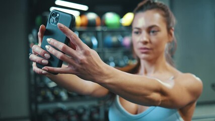 Beautiful sexy young caucasian woman taking picture selfie photo on smartphone after active gym training. Workout people. Communication. Technology. - Powered by Adobe