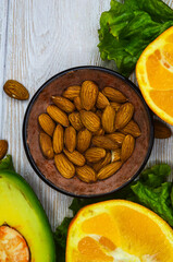 fresh vegetables and fruits, avocado, orange, lettuce, almonds, healthy and vegan food, diet concept, detox, body weight control, products for immunity
