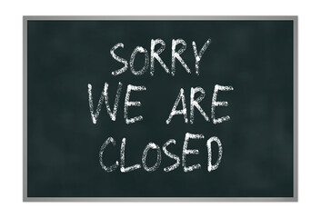 Fototapeta premium Dirty black chalkboard with silver frame, sorry we are closed is written on the board, isolated on white backgrounde