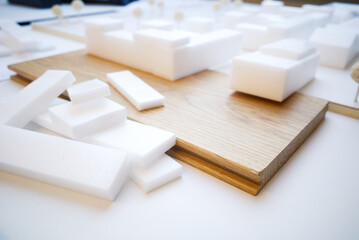 Selective focus, white architectural models. Architect's design thinking process. Urban planning model. Architecture studio working area on table.