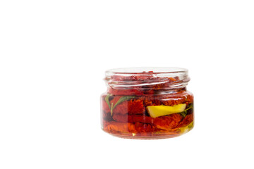 Sun-dried tomatoes in a glass jar isolated on a white background.