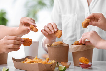 Women with buckets of tasty nuggets outdoors