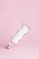Bottle of cosmetic product on color background