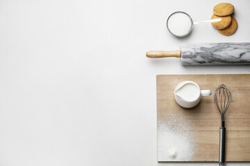 Ingredients for cookies and rolling pin on white background