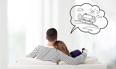 Young couple sitting on the sofa and thinking for house