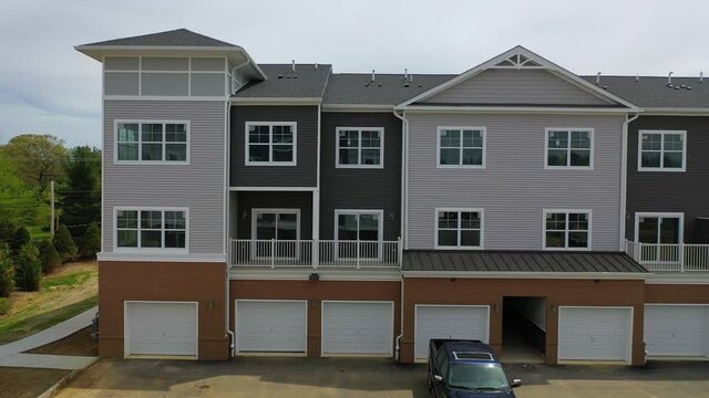 Slider Shot Right of Luxury Apartment Complex and the Indoor Car Garages