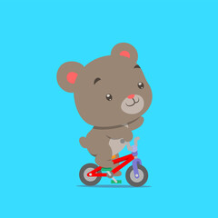 The little teddy bear is cycling with the small colorful bicycle