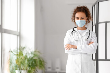 Fototapeta na wymiar Portrait of female doctor wearing medical mask in clinic