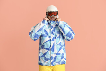 Fototapeta na wymiar Male snowboarder on color background