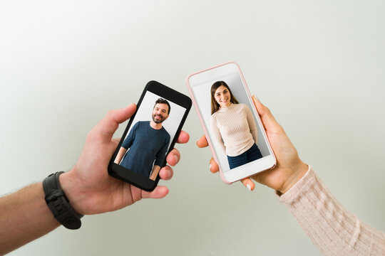 Handsome man and woman showing their profile photos on a dating app
