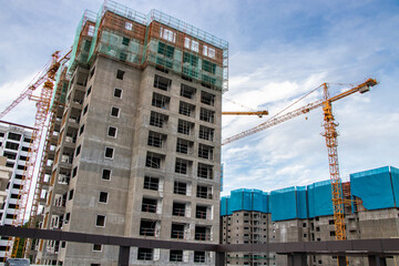 Fototapeta na wymiar Modern city buildings under construction in Asian urban area - Pampanga, Philippines