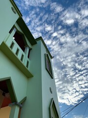 building with blue sky and clouds