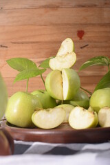 pile of green apples on a wooden background