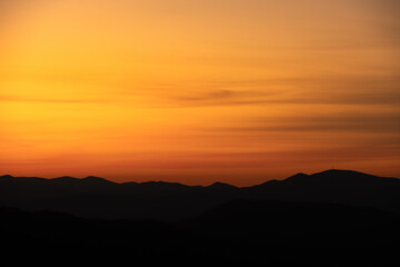Dark Mountain Ridges Stand Still Under Smearing Clouds