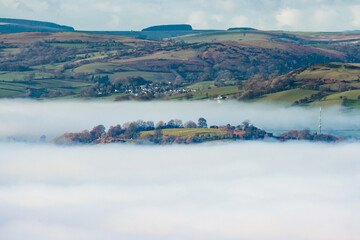 Beautiful rural farmland partially covered in low hanging fog