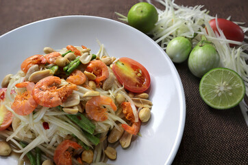 (Som Tam Thai) papaya salad. Ingredients Papaya Salad, chopped papaya, dried shrimp , lemon, tomatoes, dried peanuts. Thai Food Concept. Top View
