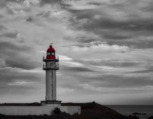 Fotobehang Old lighthouse in Gran Canaria against a grayscale sky © Juan Carlos Tacoronte/Wirestock