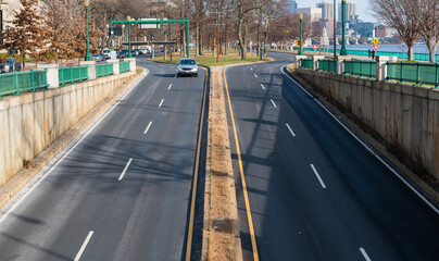 Cars driving onto the Memorial Drive roadway around the Charles River in Boston and Cambridge, Massachusetts
