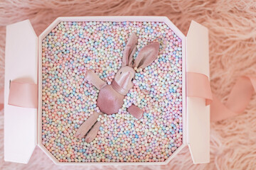 Gift box with pink rabbit. Greeting card Festive holiday pastel backdrop. Birthday congratulations. Happy valentines day, mothers day, international womens day 8 march, Christmas New Year present