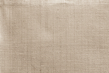 Jute hessian sackcloth canvas woven texture pattern background in light beige cream brown color...