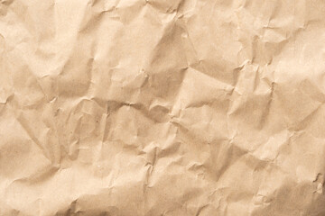 Crumpled brown paper texture perfect for background structure. Packaging material with rough wrinkles. The grunge textured surface is a vintage backdrop.