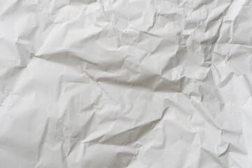 Crumpled white paper texture perfect for background structure. Packaging material with rough wrinkles. The grunge textured surface is a vintage backdrop.