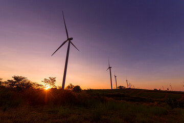 Obraz premium wind turbines park for make the electric power from wind in sunset time
