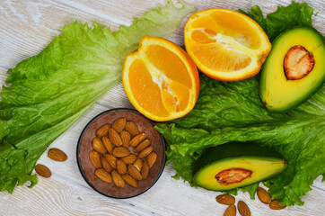 fresh vegetables and fruits, avocado, orange, lettuce, almonds, healthy and vegan food, diet concept, detox, body weight control, products for immunity