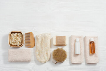 Fototapeta na wymiar Bath accessories from natural material, zero waste set for bathroom, small bottles with gel and shampoo, soap, sea salt, washcloth
