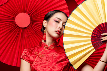 Close up portrait of beautiful stunning Asian woman wearing traditional cheongsam qipao dress...